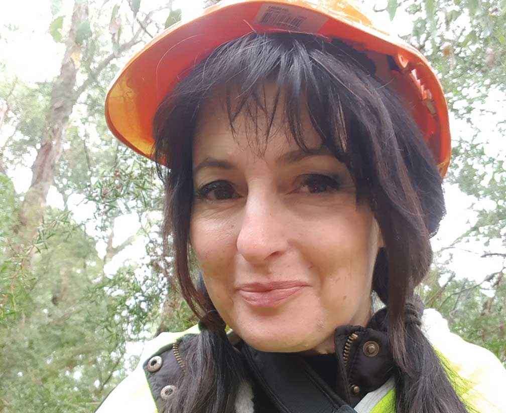 Volunteer Mariea Pacheco provides supplementary water and food to pairs of helmeted honeyeaters raising young.